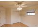 Well-lit bedroom featuring a ceiling fan, closet, and open shelving at 109 Tortuga Dr, Nokomis, FL 34275