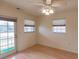 Bedroom with wood floors, ceiling fan, and sliding glass door to a balcony at 109 Tortuga Dr, Nokomis, FL 34275