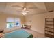 Bedroom showcasing a built-in desk area, ceiling fan, and a serene window view at 109 Tortuga Dr, Nokomis, FL 34275