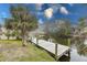 Private wooden dock on a canal surrounded by lush greenery and a tranquil setting at 109 Tortuga Dr, Nokomis, FL 34275
