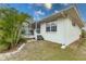Back exterior view of home with a screened-in porch and mature landscaping at 109 Tortuga Dr, Nokomis, FL 34275