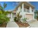 Two-story home featuring a balcony, front yard landscaping, and a clean exterior at 109 Tortuga Dr, Nokomis, FL 34275