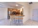 Bright kitchen features stainless steel appliances, breakfast bar, and tile flooring at 109 Tortuga Dr, Nokomis, FL 34275
