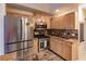 Kitchen features stainless steel appliances, wooden cabinets, and tile backsplash at 109 Tortuga Dr, Nokomis, FL 34275