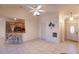 Living room with tile floors, ceiling fan, and a view of the kitchen bar with seating at 109 Tortuga Dr, Nokomis, FL 34275