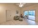 Cozy living room with tiled floors, comfortable seating, and ample natural light at 109 Tortuga Dr, Nokomis, FL 34275