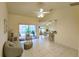Open-concept living room with tiled floors, a ceiling fan, and views of the outdoor space at 109 Tortuga Dr, Nokomis, FL 34275