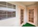 Exterior shot of a patio featuring a window and two glass-paneled doors at 109 Tortuga Dr, Nokomis, FL 34275