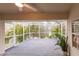 Scenic screened porch overlooking lush greenery and the water at 109 Tortuga Dr, Nokomis, FL 34275