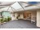 Relaxing screened porch with ceiling beams and lush plants at 109 Tortuga Dr, Nokomis, FL 34275