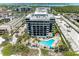 Aerial view of building and pool area, showing beach and parking at 1102 Benjamin Franklin Dr # 407, Sarasota, FL 34236