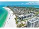 Aerial view of a luxurious beachfront condominium complex with stunning turquoise waters and white sand beaches at 1102 Benjamin Franklin Dr # 407, Sarasota, FL 34236
