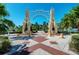 Ornate archway entrance to a park-like setting with palm trees and water views at 1102 Benjamin Franklin Dr # 407, Sarasota, FL 34236