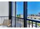 View of the water and neighborhood from the screened-in balcony area with patio furniture at 1102 Benjamin Franklin Dr # 407, Sarasota, FL 34236