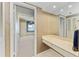 Bathroom vanity featuring a long countertop, a large mirror, and entry to the bedroom and closet at 1102 Benjamin Franklin Dr # 407, Sarasota, FL 34236