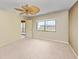 Bedroom with carpet, ceiling fan, and a large window at 1102 Benjamin Franklin Dr # 407, Sarasota, FL 34236