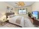 Stylishly staged bedroom with a plush bed, modern furniture, large window, and contemporary artwork at 1102 Benjamin Franklin Dr # 407, Sarasota, FL 34236