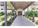 Inviting building entrance with covered walkway, landscaping, and modern design at 1102 Benjamin Franklin Dr # 407, Sarasota, FL 34236
