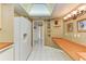 Bright kitchen with white appliances, neutral cabinetry, and tile floors at 1102 Benjamin Franklin Dr # 407, Sarasota, FL 34236