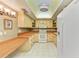 Bright kitchen featuring a skylight, white appliances, and light colored cabinetry at 1102 Benjamin Franklin Dr # 407, Sarasota, FL 34236