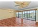 Bright living room with wood floors, a chandelier, and sliding doors to the balcony at 1102 Benjamin Franklin Dr # 407, Sarasota, FL 34236