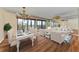 Bright living room featuring a chandelier, wood floors, and floor to ceiling windows at 1102 Benjamin Franklin Dr # 407, Sarasota, FL 34236