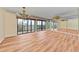 Spacious living area featuring hardwood floors and access to balcony at 1102 Benjamin Franklin Dr # 407, Sarasota, FL 34236