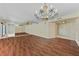 Spacious living room with mirrored wall, wood floors, and views to the entry door at 1102 Benjamin Franklin Dr # 407, Sarasota, FL 34236