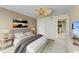 Comfortable main bedroom with en-suite bathroom, ceiling fan, and neutral colors at 1102 Benjamin Franklin Dr # 407, Sarasota, FL 34236