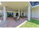Covered outdoor patio with table and chairs at 1102 Benjamin Franklin Dr # 407, Sarasota, FL 34236