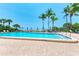 Beautiful swimming pool surrounded by palm trees with a picturesque ocean view at 1102 Benjamin Franklin Dr # 407, Sarasota, FL 34236