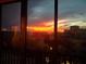 Breathtaking sunset view seen through condo window with city skyline at 1102 Benjamin Franklin Dr # 407, Sarasota, FL 34236