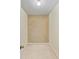 An empty walk-in closet featuring carpet floors and textured wallpaper, ready to be filled with storage solutions at 1102 Benjamin Franklin Dr # 407, Sarasota, FL 34236