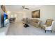 Living room with beige couch, coffee table, and hardwood floors at 12440 Amica Loop, Venice, FL 34293