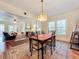Open dining room with hardwood floors, chandelier, and view of living room at 1420 22Nd W St, Bradenton, FL 34205