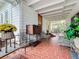 Relaxing front porch with brick flooring and vintage furniture at 1420 22Nd W St, Bradenton, FL 34205