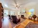 Spacious living room featuring hardwood floors, a fireplace, and built-in shelving at 1420 22Nd W St, Bradenton, FL 34205