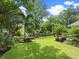 Expansive lawn with tropical landscaping, creating a private oasis at 1621 Pine Bay Dr, Sarasota, FL 34231