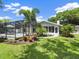 Landscaped backyard with a refreshing pool and lush greenery at 1621 Pine Bay Dr, Sarasota, FL 34231