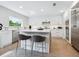 Modern kitchen with white cabinets, quartz countertops, and stainless steel appliances at 1621 Pine Bay Dr, Sarasota, FL 34231