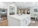 Modern kitchen with white cabinets, stainless steel appliances, and an island at 1621 Pine Bay Dr, Sarasota, FL 34231