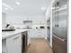 Modern white kitchen with stainless steel appliances and an island at 1621 Pine Bay Dr, Sarasota, FL 34231