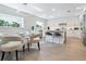 White kitchen with a breakfast bar, stainless steel appliances, and a geometric backsplash at 1621 Pine Bay Dr, Sarasota, FL 34231