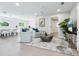 Light-filled living room with comfortable seating and a view of the kitchen at 1621 Pine Bay Dr, Sarasota, FL 34231