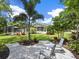Spacious patio with seating, overlooking the lush backyard at 1621 Pine Bay Dr, Sarasota, FL 34231