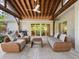 Relaxing covered patio with wicker furniture and view of the house at 1621 Pine Bay Dr, Sarasota, FL 34231