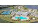 Aerial view of community pool, tennis, pickleball courts, and clubhouse at 17923 Polo Trl, Bradenton, FL 34211