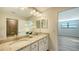 Double vanity bathroom with granite countertop and view of bedroom at 17923 Polo Trl, Bradenton, FL 34211