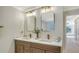 Modern bathroom with a double vanity and updated lighting at 17923 Polo Trl, Bradenton, FL 34211