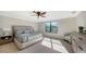 Main bedroom with large bed, nightstands and window at 17923 Polo Trl, Bradenton, FL 34211